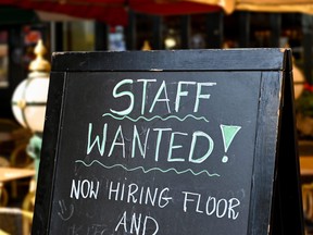A wanted sign is shown outside a restaurant. Getty Images