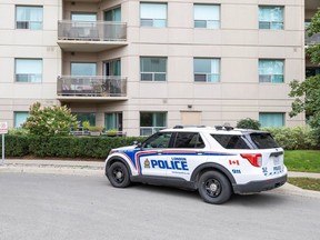 A London police vehicle is parked outside 565 Proudfoot Lane in London on Friday, Sept. 8, 2023. Police are investigating the discovery of two bodies in an apartment at the building. (Derek Ruttan/London Free Press)