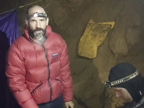 In this screen grab from video, American caver Mark Dickey, 40, talks to a camera next to a colleague inside the Morca cave near Anamur, southern Turkey, Thursday, Sept. 7, 2023.