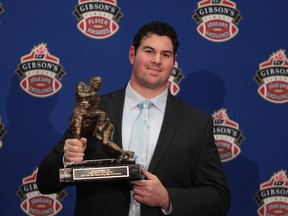 Then Montreal Alouettes' offensive tackle Josh Bourke holds his trophy after winning the CFL Most Outstanding Lineman in 2011.