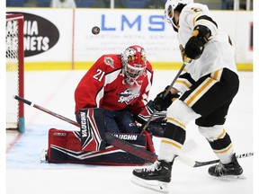 Windsor Spitfires goalie Ian Michelone makes a save on the Sarnia Sting's Nathan Omeri during Wednesday's exhibition game. Mark Malone/Chatham Daily News/Postmedia Network
