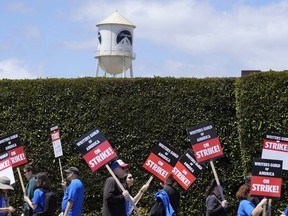 FILE - Striking writers take part in a rally in front of Paramount Pictures studio, Tuesday, May 2, 2023, in Los Angeles. A tentative deal was reached, Sunday, Sept. 24, 2023, to end Hollywood's writers strike after nearly five months.