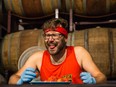 Mike Jack finishes one of the 135 Carolina Reaper peppers that he scarfed down on Nov. 5, 2022, at Forked River Brewing Company in London, Ont.