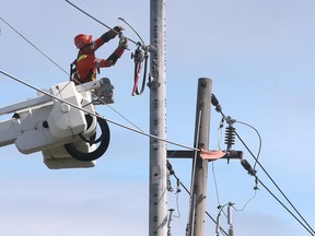 Worker installs hydro lines