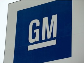 In this file photo taken on January 27, 2020 a sign with the General Motors (GM) logo is seen outside the GM Detroit- Hamtramck assembly plant in Detroit, Michigan.