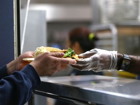 A Thanksgiving meal is served by volunteers to clients at the Mustard Seed.