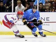 Sarnia Sting's Sandis Vilmanis (22) is checked by Kitchener Rangers' Carson Campbell (8) at Progressive Auto Sales Arena in Sarnia, Ont., on Wednesday, Oct. 4, 2023. (Mark Malone/Postmedia Network)