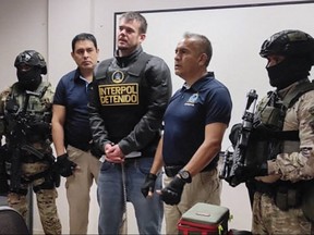 This handout picture released by Interpol Peru shows Peruvian police and Interpol agents handing over Dutch Joran Van der Sloot to FBI agents for a temporary extradition to the United States in Callao, Peru on June 8, 2023.