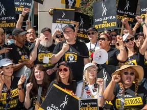 Duncan Crabtree-Ireland (C), executive director and chief negotiator for SAG AFTRA, and the members of the negotiating committee address the SAG AFTRA members at the picket line outside of Warner Brothers in Burbank, California, on October 3, 2023.