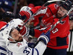 Tom Wilson of the Washington Capitals checks Timothy Liljegren of the Toronto Maple Leafs at Capital One Arena on October 24, 2023 in Washington.