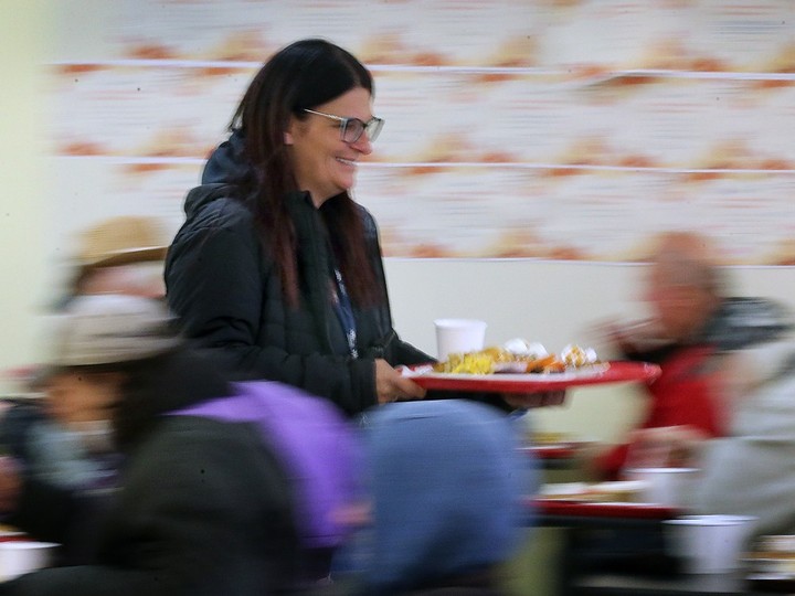  The Downtown Mission hosted a free Thanksgiving Meal on Tuesday, Oct. 10, 2023. Staffer Jody Perron serves meals during the event.