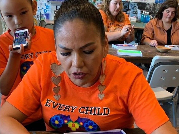  Art Windsor-Essex artist in residence Krystal Bigsky, right, helps Nakaa Onica with bead work on an orange shirt pin on the National Day for Truth and Reconciliation on Saturday, Sept. 30, 2023.