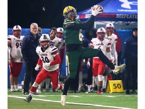 St. Clair Saints' receiver Darius France leaps for a catch as London Beefeaters' defensive back Zach Hepburn moves in during Saturday's OFC final at Acumen Stadium.