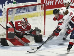 Ottawa 67s goalie Max Donoso, who is from Windsor, makes a save on Windsor Spitfires' forward Oliver Peer during Thursday's game at the WFCU Centre.