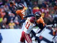 Denver Broncos safety Justin Simmons, left, intercepts a pass intended for Kansas City Chiefs wide receiver Marquez Valdes-Scantling.