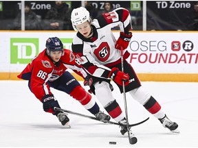 Windsor Spitfires' forward Cole Davis ( No. 86) tries to chase down the Ottawa 67's Henry Mews (No. 11) during Sunday's game at TD Place.