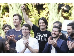 Miguel McKelvey, right, and Adam Neumann, co-founders of WeWork, during a group photograph at an event on the sidelines of the company's trading debut in New York, U.S., on Thursday, Oct. 21, 2021. As WeWork completes its second attempt to go public, this time through a SPAC valuing the combined company at $9 billion, Neumann's name is peppered 197 times throughout the business combination filing, even though he's no longer an employee or board member.
