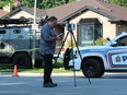 A member of the Special Investigations Unit collects evidence outside of 66 Glenroy Rd., where London police fatally shot a man, 35, who was a suspect in an attempted vehicle theft and shooting earlier in the day. Photo taken on July 21, 2023. Dale Carruthers / The London Free Press