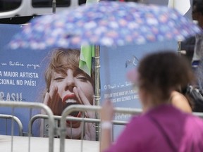 Taylor Swift fan waits for the doors of Nilton Santos Olympic stadium to open for her Eras Tour concert amid a heat wave in Rio de Janeiro, Brazil, Saturday, Nov. 18, 2023.