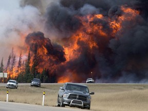 FILE - A wildfire burns south of Fort McMurray, Alberta, near Highway 63 on Saturday, May 7, 2016. A book about an inferno that ravaged a Canadian city and has been called a portent of climate chaos has won Britain's leading nonfiction book prize. John Valliant's "Fire Weather: A True Story from a Hotter World" was awarded the 50,000 pound ($62,000) Baillie Gifford Prize at a ceremony in London on Thursday, Nov. 16, 2023.