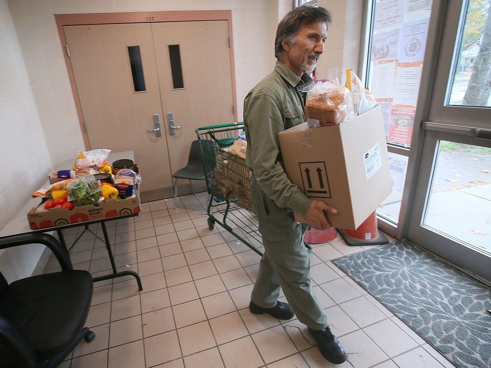 Amir Akhtar, a volunteer at The Salvation Army &mdash; Windsor Centre of Hope, prepares to hand out food at the organization's downtown food bank on Monday, Oct. 30, 2023.