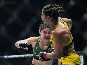 Mexico's Loopy Godinez, left, punches Brazil's Tabatha Ricci during the third round of a women's strawweight bout at the UFC 295 mixed martial arts event Saturday, Nov. 11, 2023, in New York. Godinez won the fight.