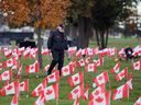 'Never forgotten.' Windsor Veterans Memorial Services Committee president Paul Lauzon is shown at the Heavenly Rest cemetery's veterans section on Tuesday, Nov. 7, 2023. Members of the committee plant up to a thousand flags at local gravesites each November around Remembrance Day.