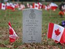 'We will never forget them.' The gravestone of Cpl. Andrew Grenon of Windsor is shown at the Heavenly Rest cemetery's veterans section on Tuesday, Nov. 7, 2023. Local volunteers plant Canadian flags on every veteran's grave they can can find as part of Remembrance Day commemorations.