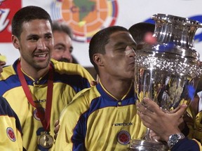 Canada will have to win a play-in match in March to get to Copa America for the first time, thanks to Tuesday's quarterfinal loss to Jamaica in the CONCACAF Nations League. Colombia's defender Mario Yepes, left, watches striker Ivan Cordoba kissing the Copa America trophy after the Copa America final game in Bogota, Sunday, July 29, 2001. Cordoba scored the goal to defeat Mexico 1-0.
