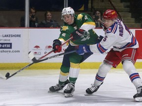 Windsor Spitfires' forward A.J. Spellacy, left, gets tied up by the Kitchener Rangers' Matthew Andonovski during Thursday's game.