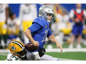 Detroit Lions quarterback Jared Goff (right) is stripped of the ball by Green Bay's Karl Brooks during the U.S. Thanksgiving Day game in Detroit.