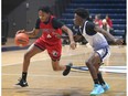 The Holy Names Knights' Austin Brown, left, works to the basket during play at the 65th University of Windsor Invitational High School Boys' Basketball Tournament at the Toldo Lancer Centre.