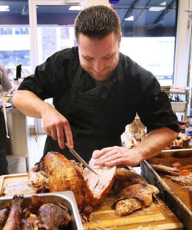 Jeremy Tofflemire carves a turkey