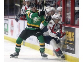 London Knights' forward Max McCue, left, collides with Windsor Spitfires' defenceman Carson Woodall during Thursday's game at the WFCU Centre.