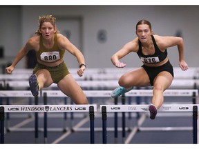 Ella Koller, left, and Lilly Jackson compete in the women's 60-metre hurdles heats on Tuesday during the Blue and Gold intrasquad meet at the Dennis Fairall Fieldhouse.