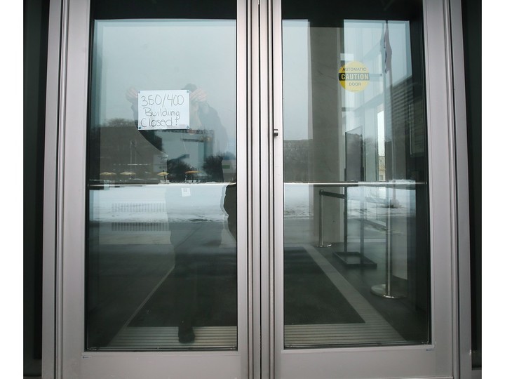  A worker places a notice at the main entrance to Windsor City Hall on Tuesday, January 23, 2024. A transformer fire knocked out the power to the City Hall building and nearby 400 building.