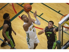 The St. Clair Saints Jesiah Deerr, center, was named the Mason MacDonald Graduating Athlete of the Year Award on the men's side.
