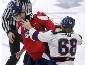 Windsor Spitfires' defenceman Tanner Winegard, left, and Saginaw Spirit forward Ethan Hay fight during Thursday's game at the WFCU Centre.