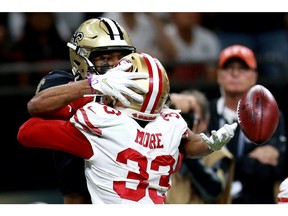 Former New Orleans receiver Tre'Quan Smith, who has signed with the Detroit Lions, tries to reach behind San Francisco 49ers' defender Tarvarius Moore to make a catch.
