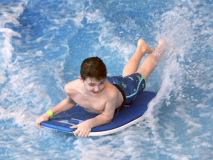  A youngster tries out the thrilling FlowRider during Adventure Bay Family Water Park’s 10th birthday on Family Day on Monday.