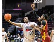 Windsor Express centre Paul Harrison, left, drives to the basket as the Newfoundland Rogues' William Brown pressures on Wednesday.