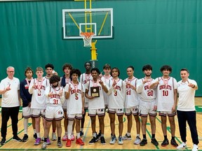 The Holy Names Knights pose on Sunday at the St. Clair College SportsPlex after winning back-to-back WECSSAA senior boys' AAA basketball titles. for the victory photo after winning back-to-back WECSSAA senior boys' AAA basketball title.
