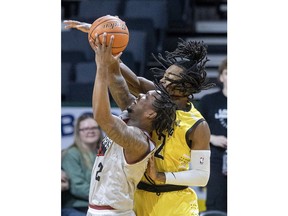 The London Lightning's Jachai Taylor, right, fouls the Windsor Express' Willie Atwood going to the basket during Tuesday's game at Budweiser Gardens.
