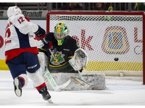 Windsor Spitfires' centre Ryan Abraham oscores on a penalty shot past the glove of London Knights' goalie Michael Simpson during Monday's game at Budweiser Gardens.