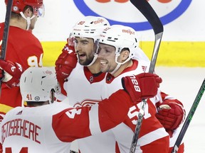 Detroit Red Wings LW David Perron, rt, Detroit Red Wings left wing David Perron (57) celebrates his goal against the Calgary Flames with teammates during second period NHL hockey action in Calgary on Saturday, Feb. 17, 2024.