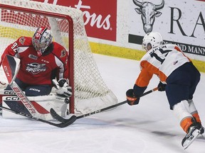 Windsor Spitfire goalie Max Donoso makes a stop against the Flint Firebirds' Jeremy Martin during a game at the WFCU Centre.