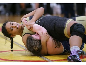 Riverside's Mariah Mixon, on top, of Riverside handles Kennedy's Jalyn Janisse at the WECSSAA wrestling championship. Mixon on went on to win gold in the 77kg division while Janisse won the bronze medal.