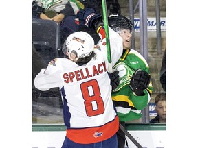 Windsor Spitfires' forward A.J. Spellacy tales London Knights' defenceman Sam Dickinson into the boards during Friday's game.