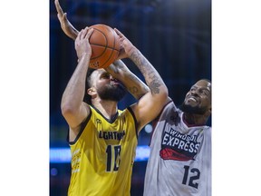 Windsor Express centre Sam Muldrow, right, attempts to block a shot attempt by the London Lightning's Jermaine Haley during Sunday's game at Budweiser Gardens.