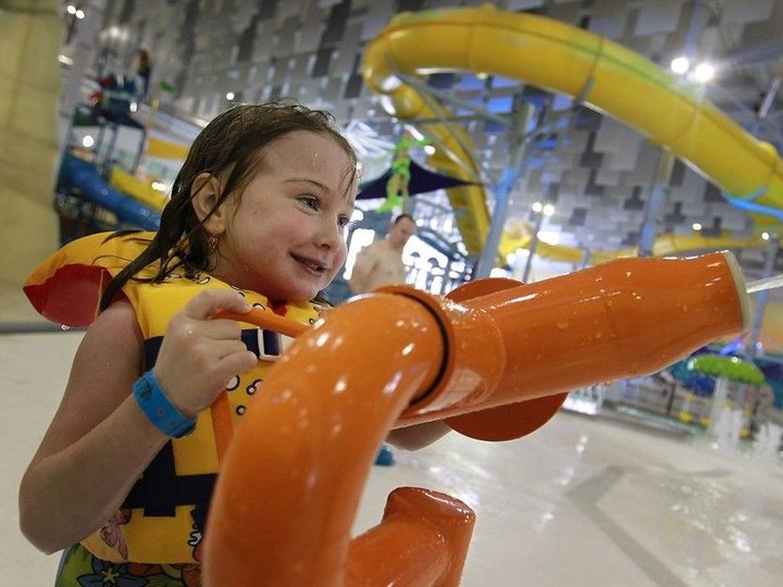  A youngster has fun with a water cannon in the wave pool at the official opening of the Adventure Bay Family Water Park in downtown Windsor on Jan. 18, 2014.